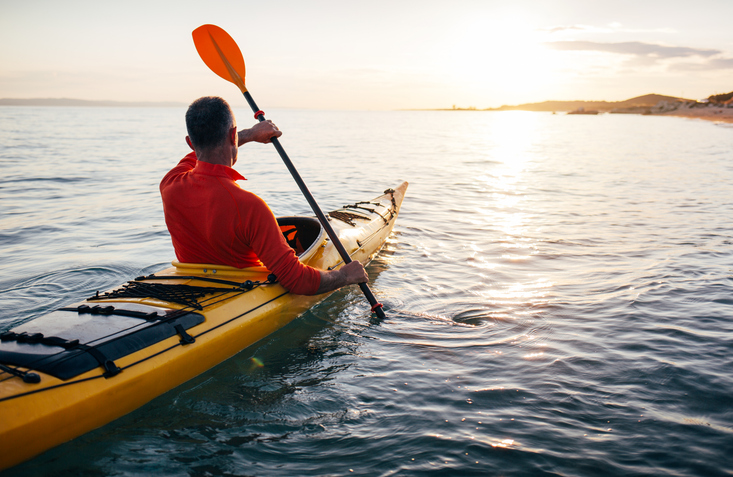 Kayaking on the water at sunset